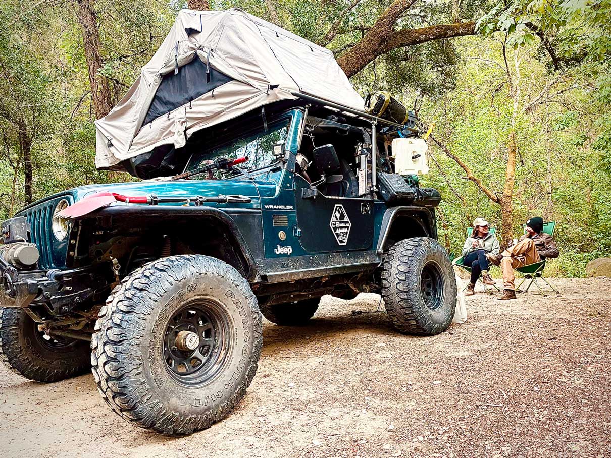 Overland couple by their jeep