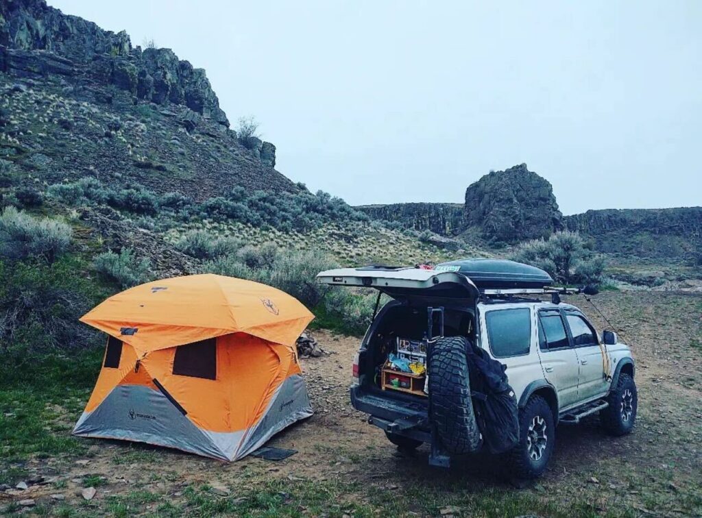 A 4 Runner parked in the desert with a Gazelle Tent next to it.