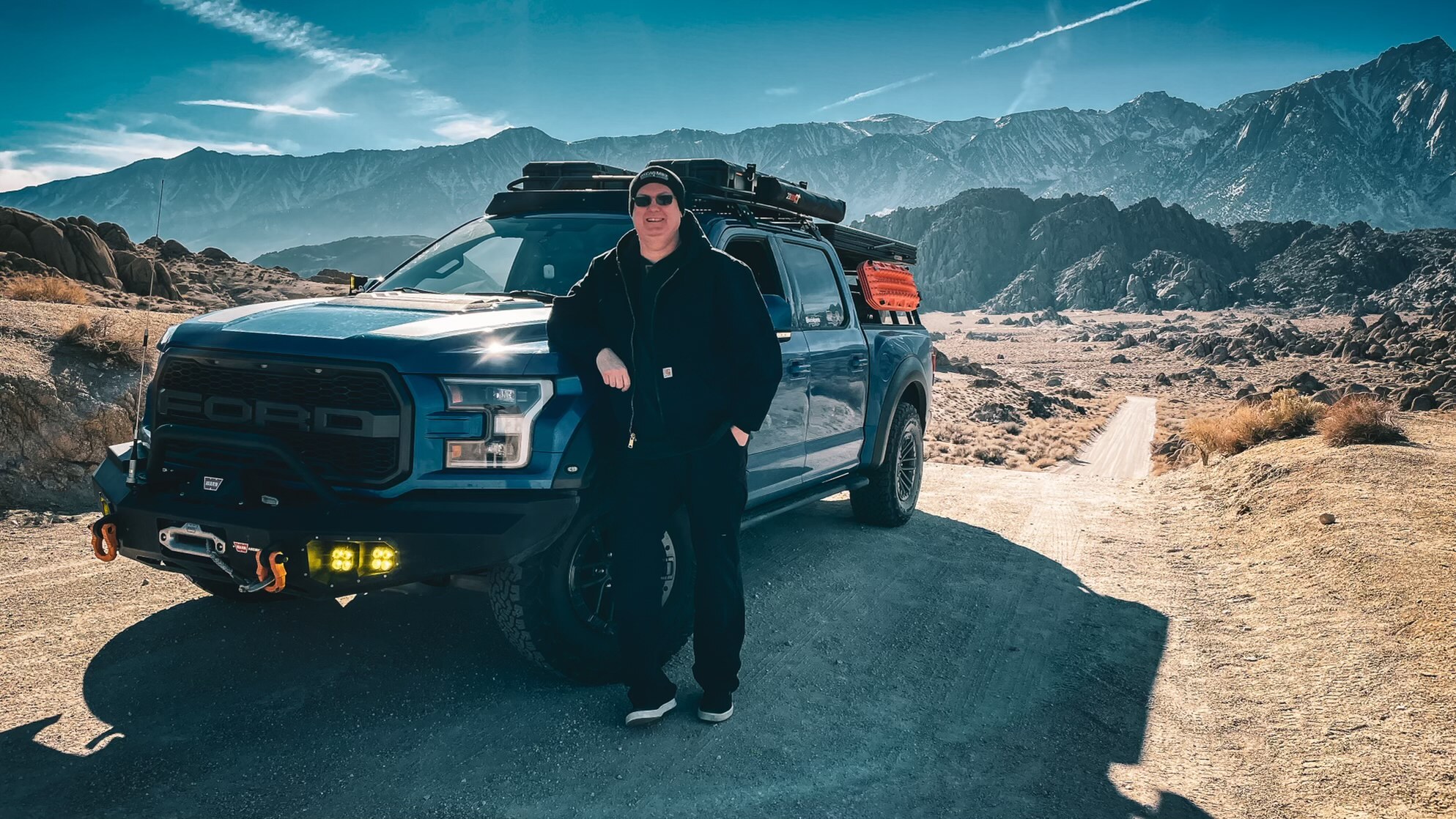 Man posing next to overland vehicle