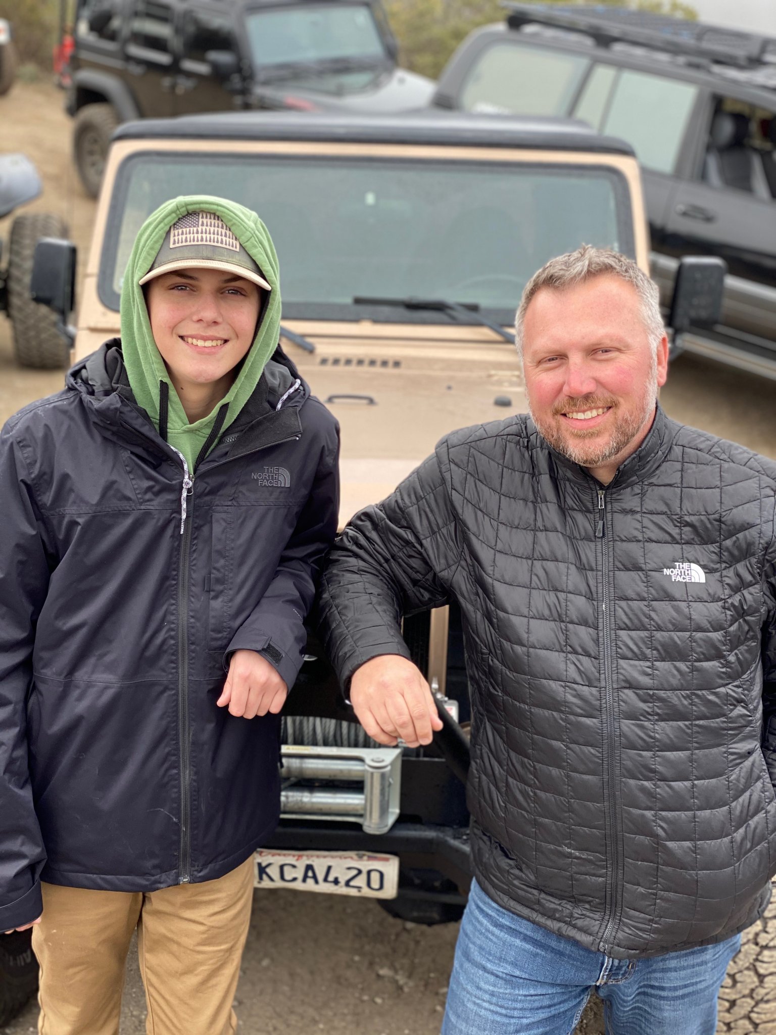 Dave Addington poses in front of his overland vehicle with his son.